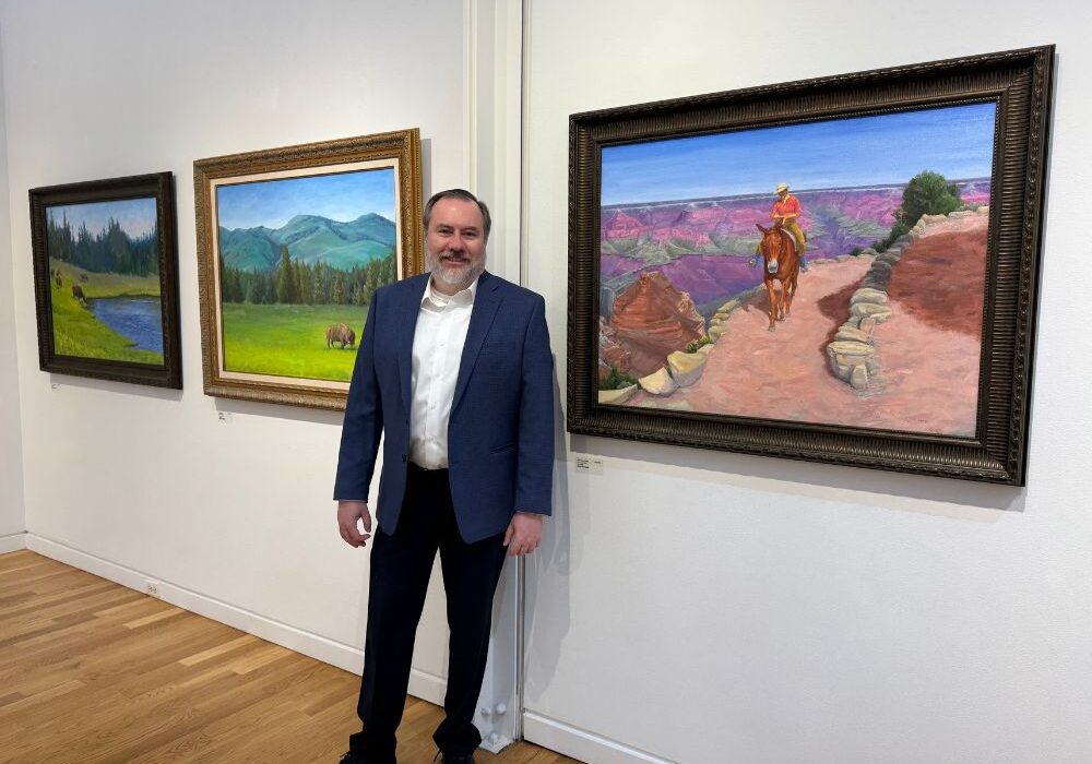 Fred-Mosss-own-artist-exhibition-at-the-Elmhurst-Art-Museum-entitled-Moments-in-Time_-A-Visual-Voyage_-ran-from-November-1-28.-Painting-to-his-left-is-_The-Grand-Trail