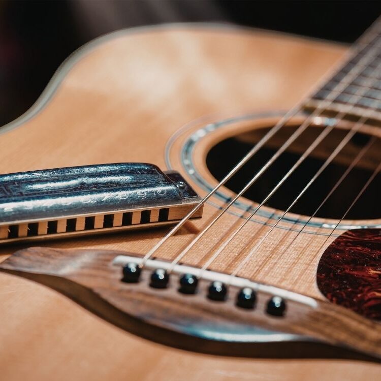 Harmonica sitting on guitar