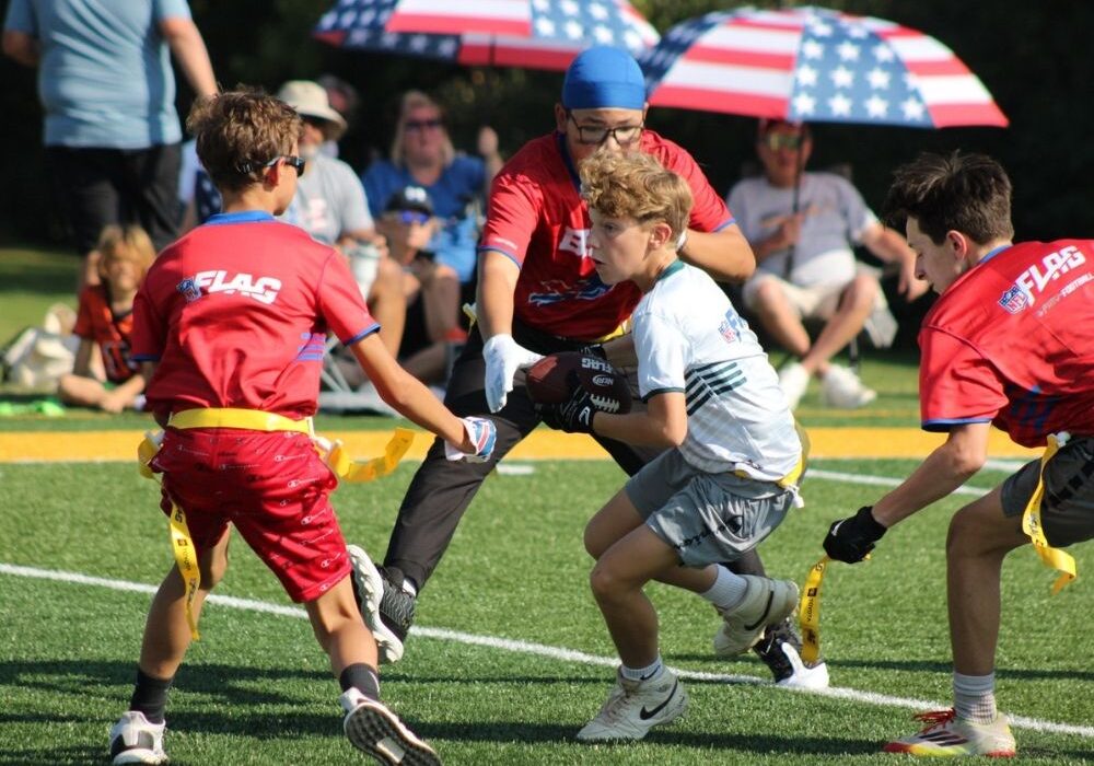 Sunday Funday players run a play in flag football last fall